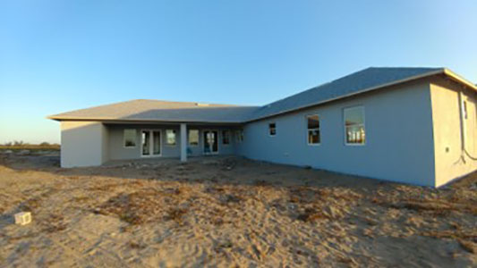 back of house with stucco