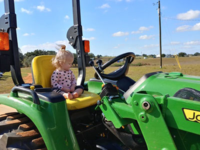 granddaughter Brooke on tractor