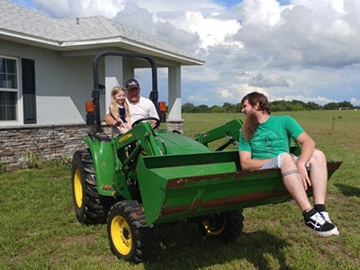 granddaughter Raina and son Cory on tractor